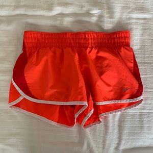 Orange and red Nike running shorts
